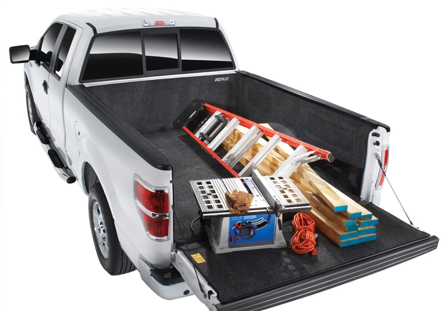 BedRug® Complete Truck Bed Liner BEDRUG 07-18 GM SILVERADO/SIERRA 5ft. 8in. BED holding construction tools and lumber