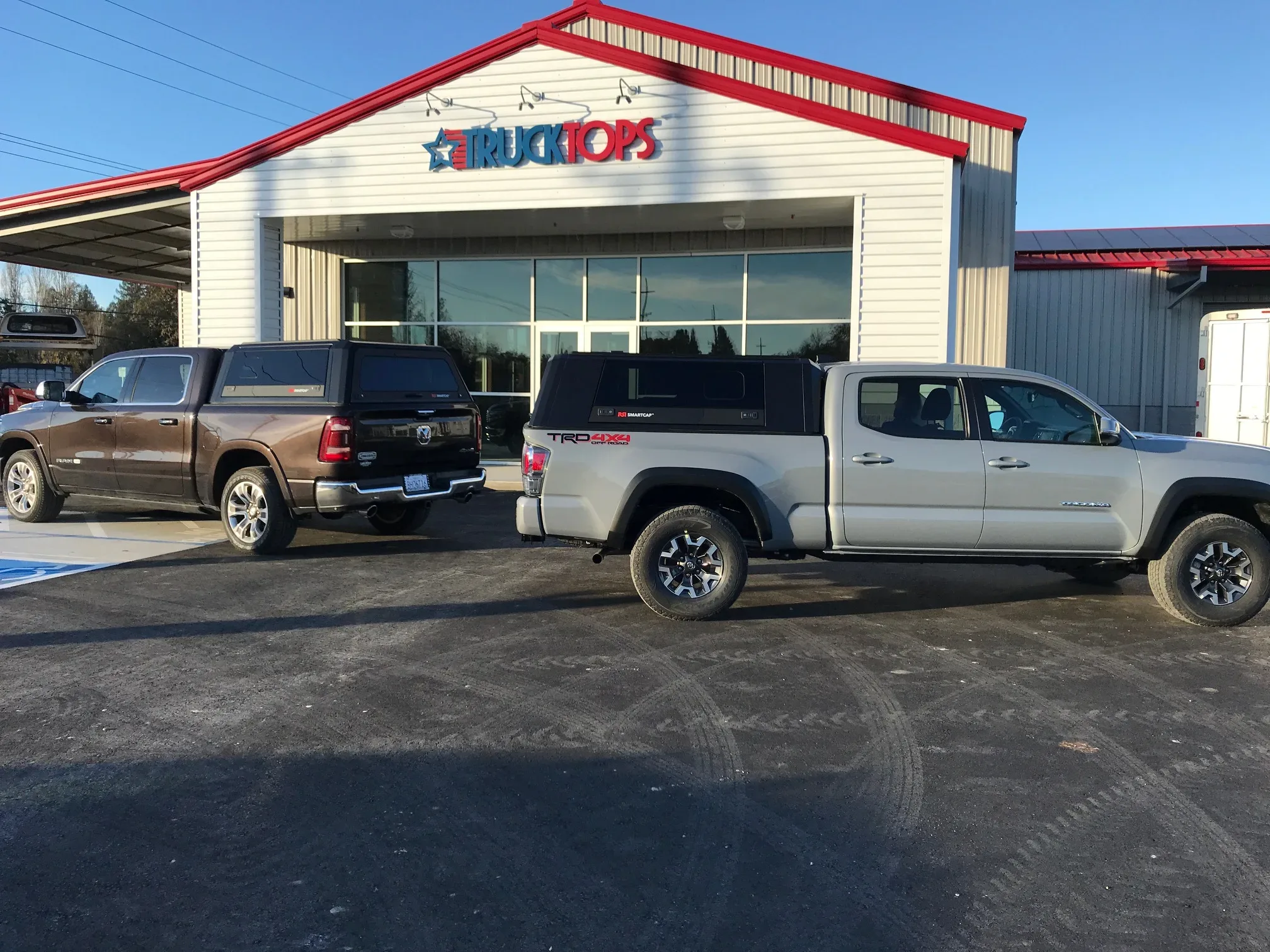 two trucks with truck caps parked outside truck tops usa in santa rosa, ca
