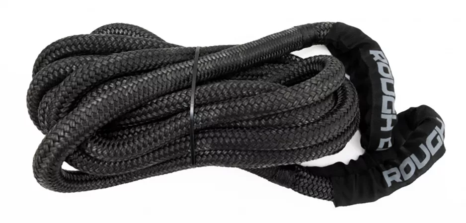 Coiled and strapped black kinetic recovery rope with "ROUGH" written on ends, by the brand Rough Country, for off-roading and overlanding
