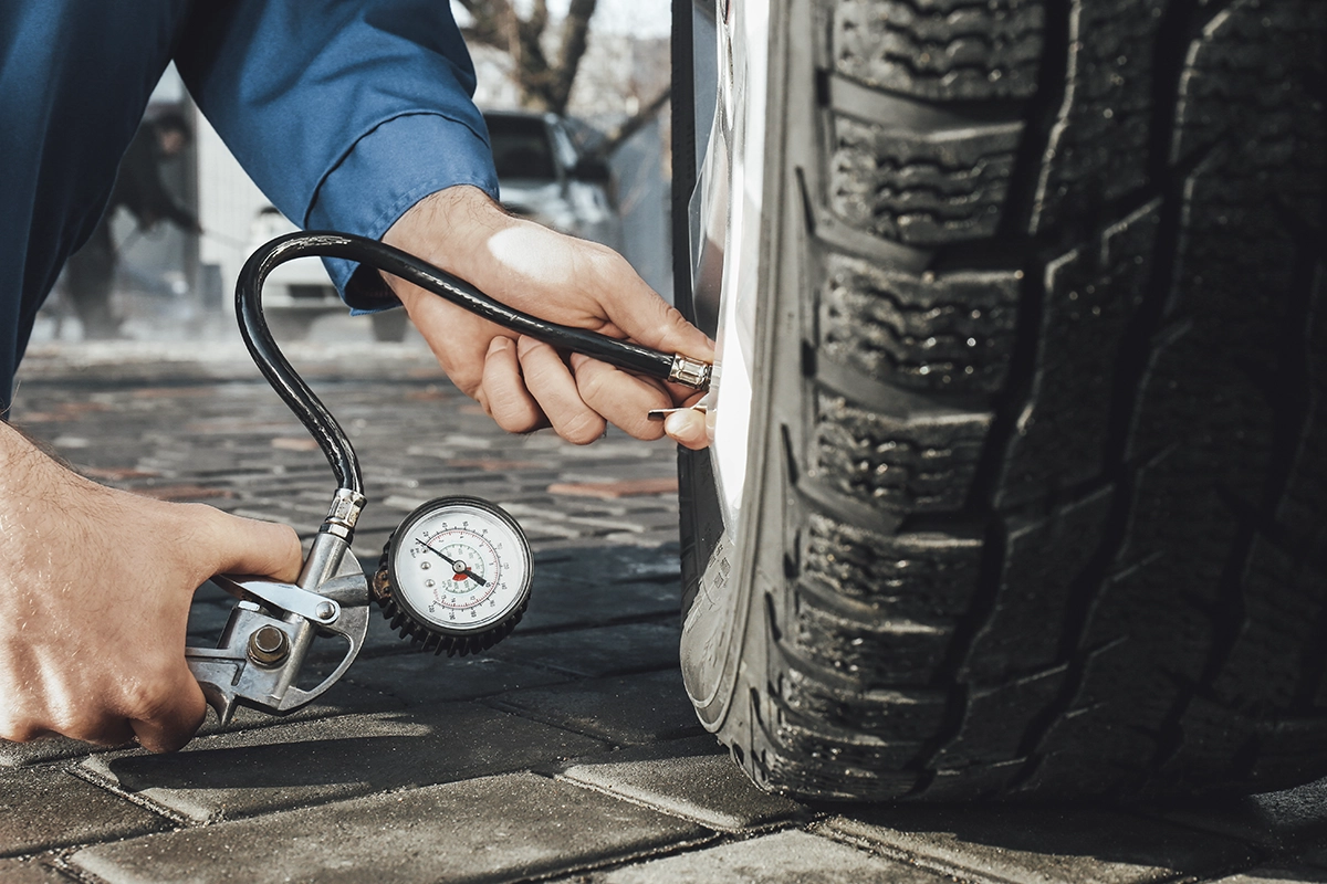 Checking the tire pressure of a commercial fleet vehicle, a work van or a truck, as part of routine maintenance