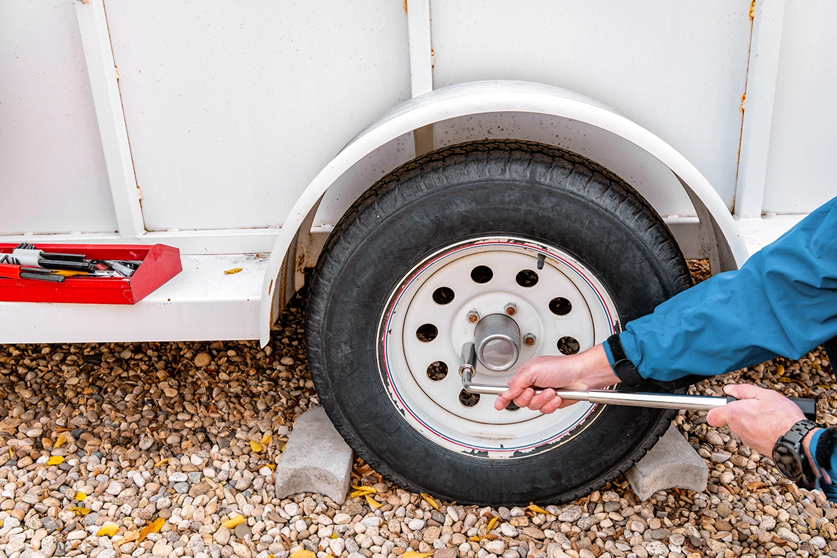 A technician repairing a trailer tire