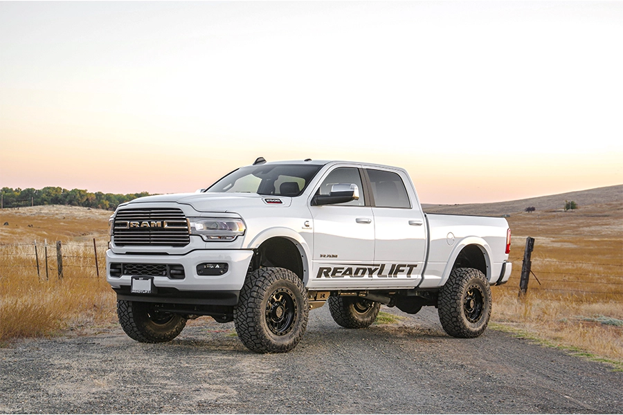 A white pickup truck with a ReadyLift suspension kit