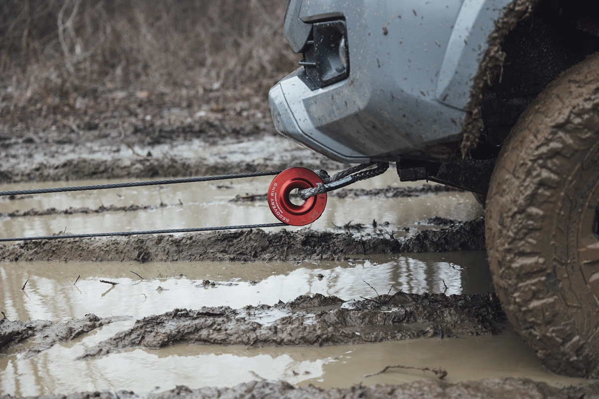 A Rough Country red recovery ring or donut pulling vehicle out of the mud, showing the concept of overlanding and off-roading recovery gear