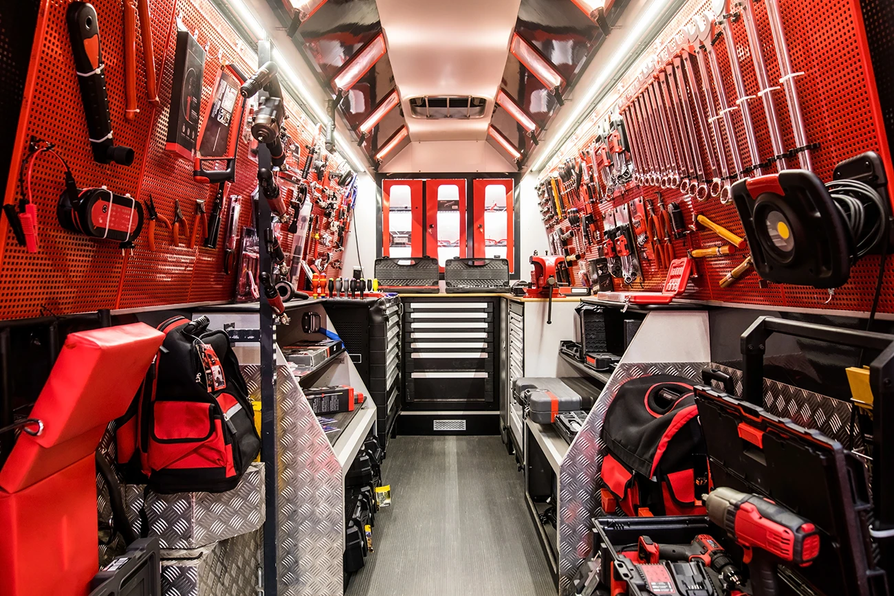 A very well organized commercial work can, and mobile workshop van with organized shelving units, drawer systems, and various work tools and other gear
