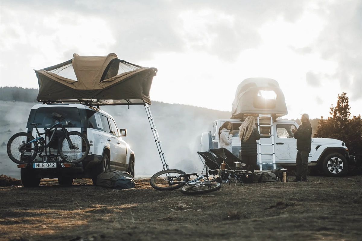 White SUVs at a campground with Thule Approach softshell rooftop tents