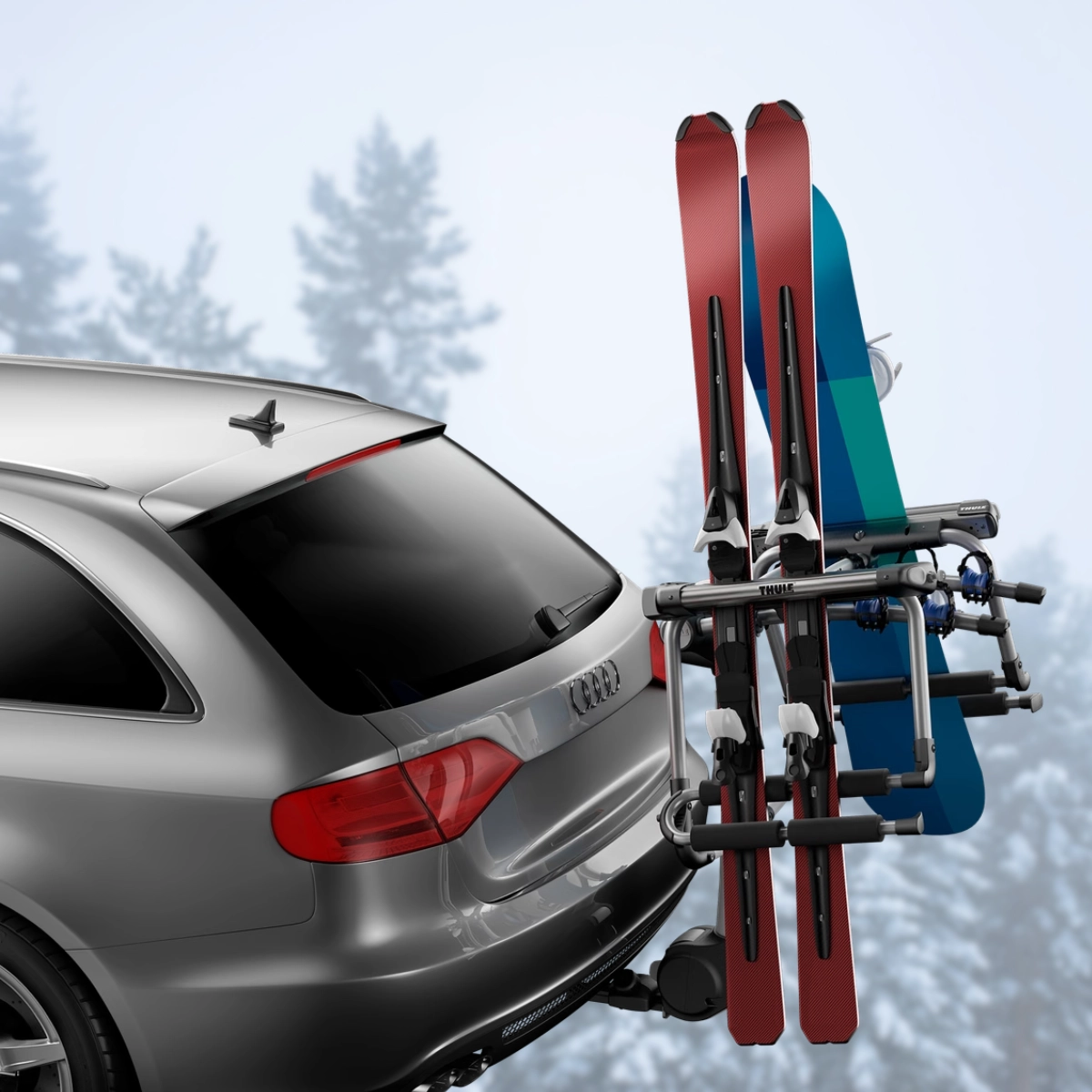 A Thule Tram hitch-mounted ski and snowboard rack attached to the back of a gray SUV