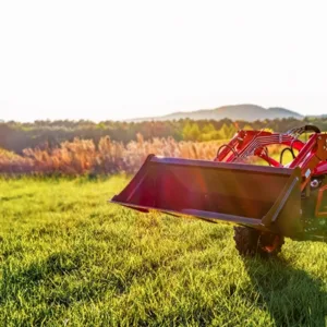 A red TYM tractor on a green field