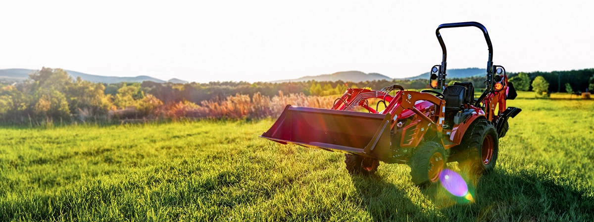 A red TYM tractor on a green field
