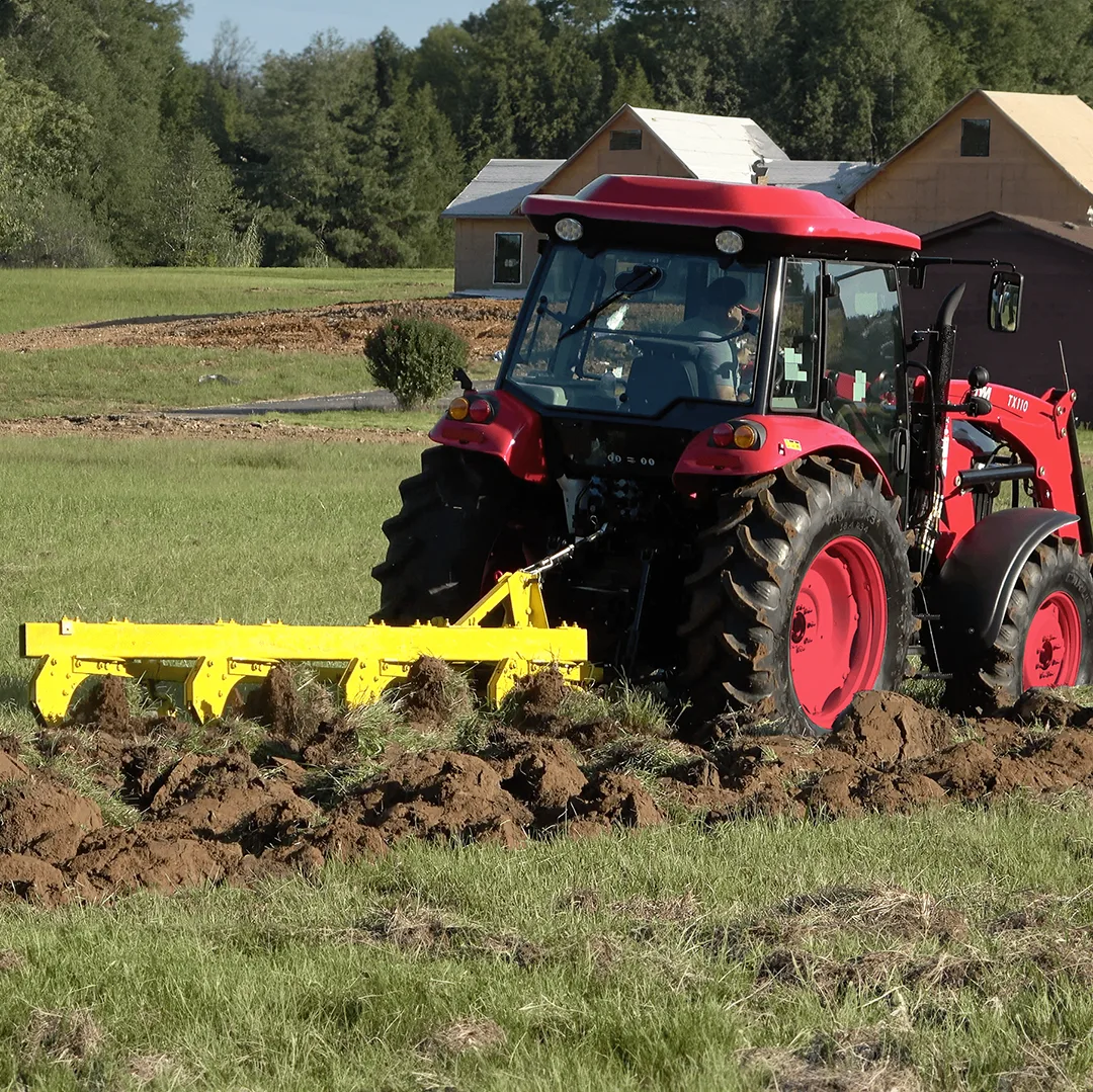 TYM Tractor using a tillage attachment for soil prep. TYM tractors have universal attachment compatibilities.